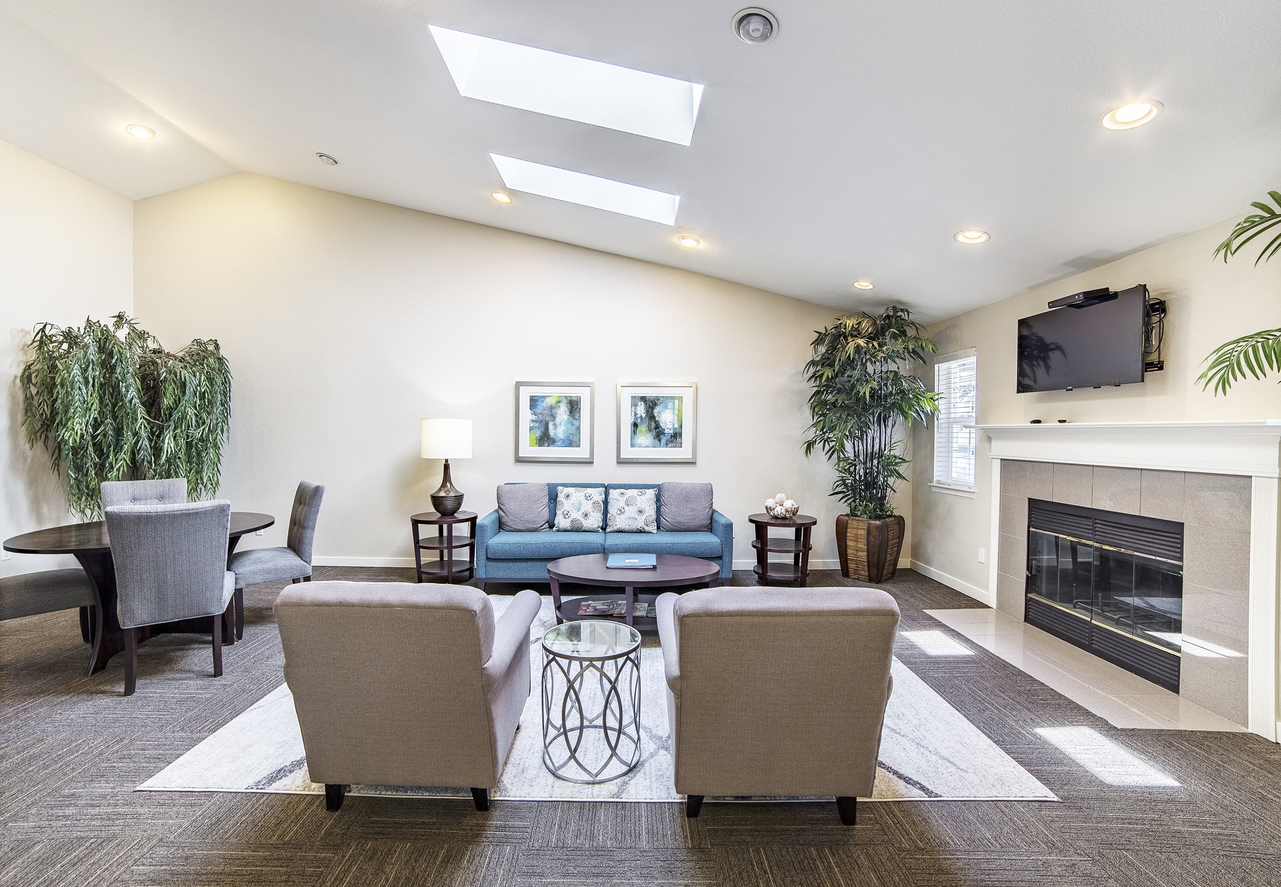 a living room with couches and chairs and a fireplace at Arterra Apartments, Kent, 98030